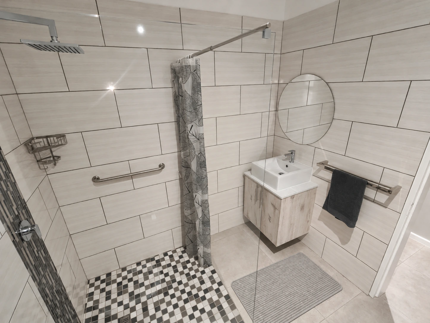 Bathroom with shower, basin, mirror and support rail; floor mat digitally added