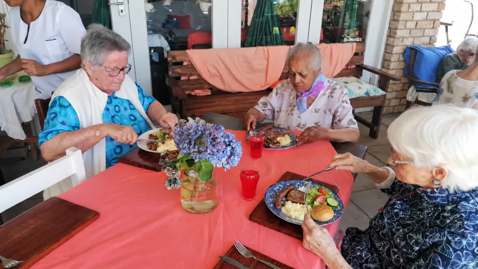 Residents enjoying a shared meal at El Shaddai